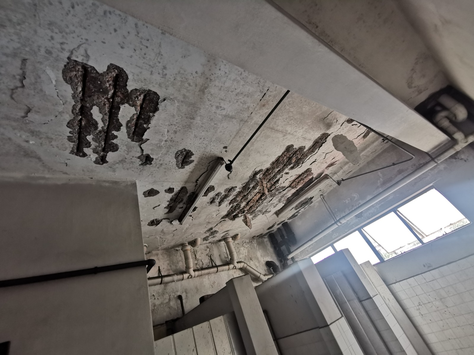 Concrete repair works in progress with damaged material removed and surfaces prepared