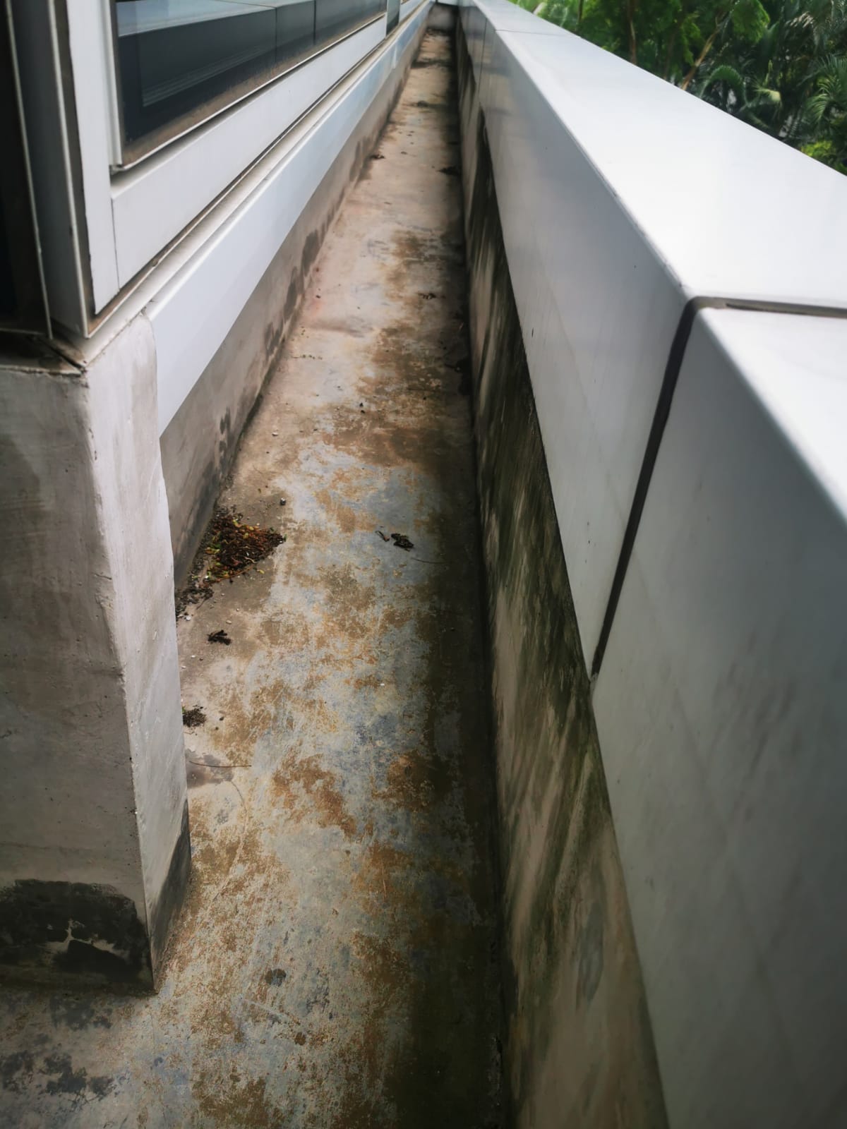 Reinforced concrete gutter before repair showing cracked and deteriorated surface